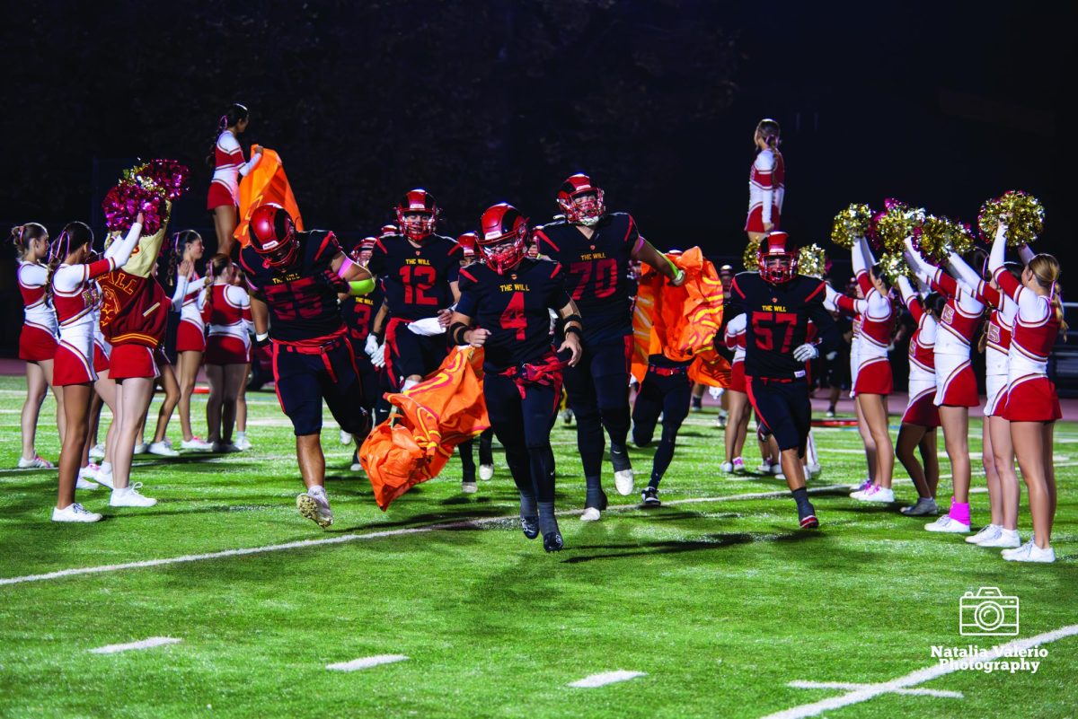 Cheer team welcomes the football team
onto the field for their homecoming game, photo by Natalia Valerio.