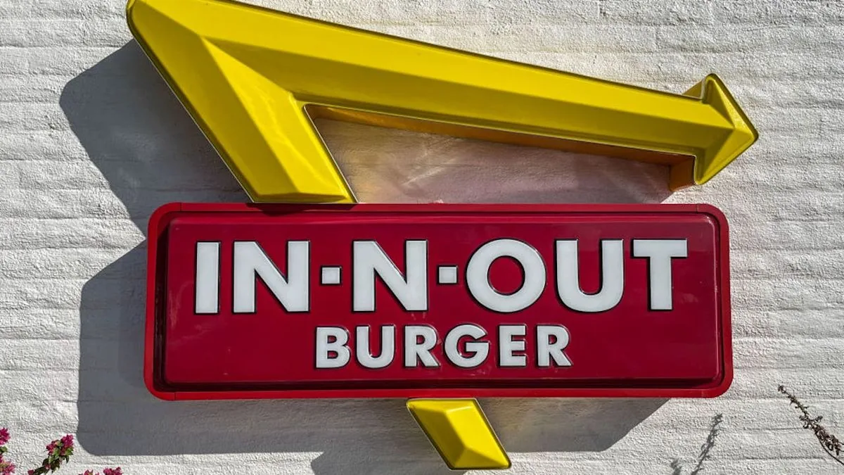 Police investigate a shooting scene in the parking lot of a Tucson In-N-Out Burger